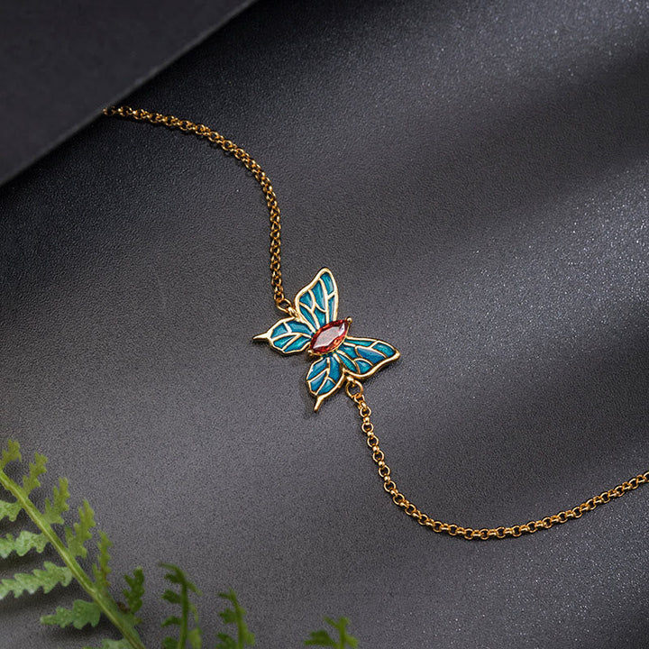 Goldenes Armband mit türkisem Schmetterling Anhänger Schmuck.