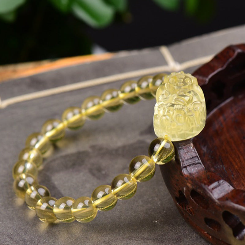 Armband Citrin Pixiu – Wohlstand mit gelbem Stein Flachlage Holz