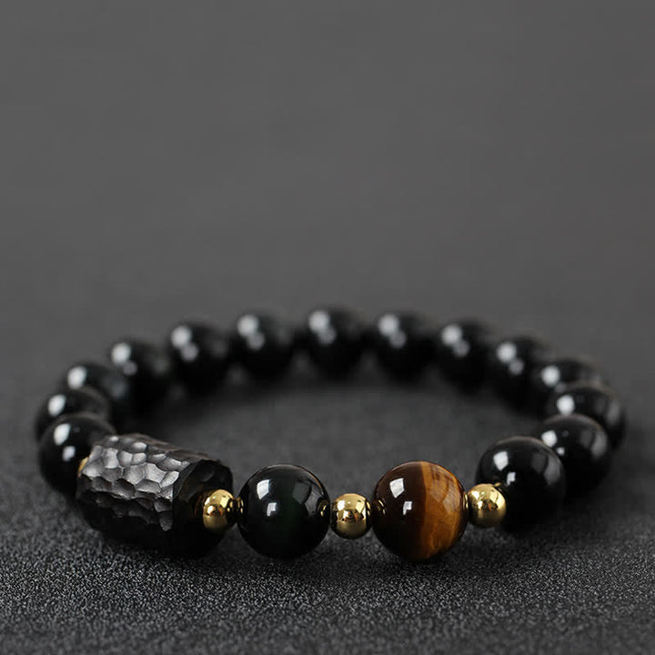 Schwarzer Obsidian Tigerauge Armband mit goldenen Perlen elastisch.