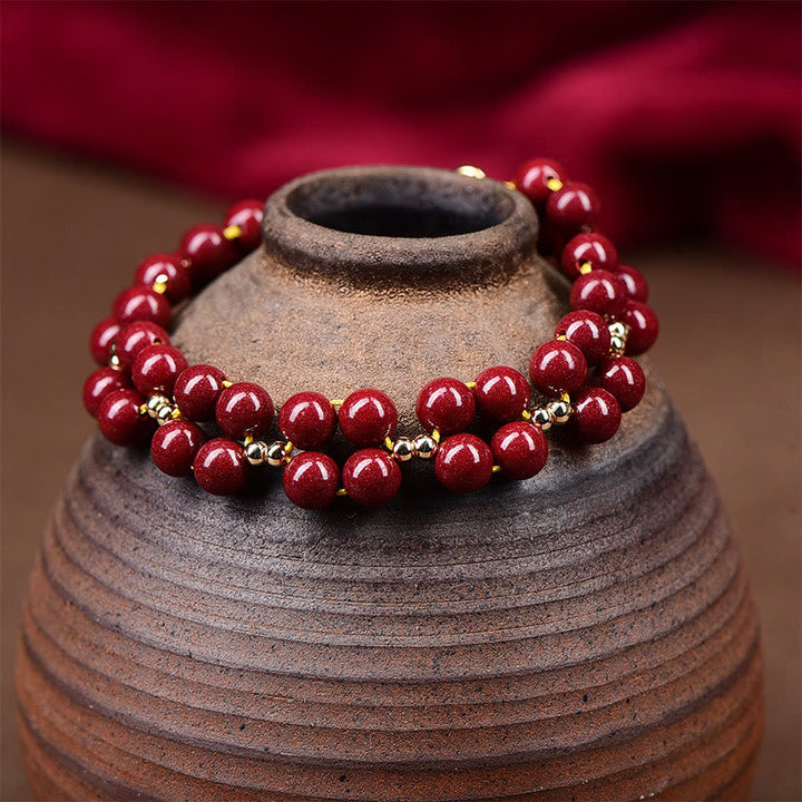 Armband Zinnober – Segen Harmonie rote Perlen Goldakzente Naturstein elegant
