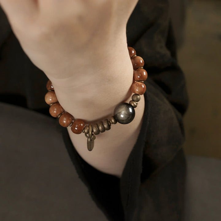 Armband Tigerauge Obsidian – Glück & Wohlstand am Handgelenk getragen braun silber