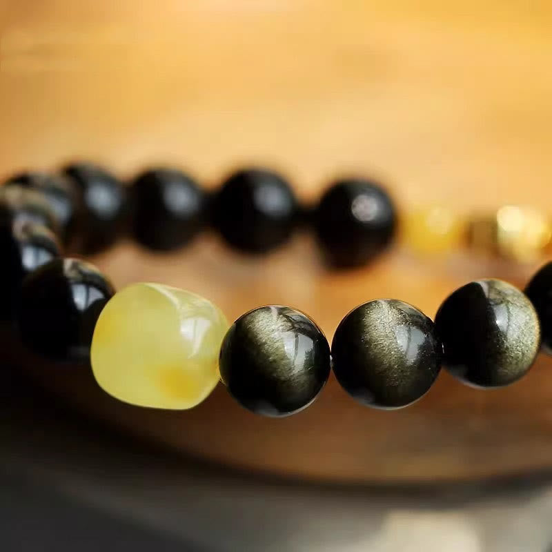Armband mit schwarzem Obsidian und gelbem Stein elastisch getragen