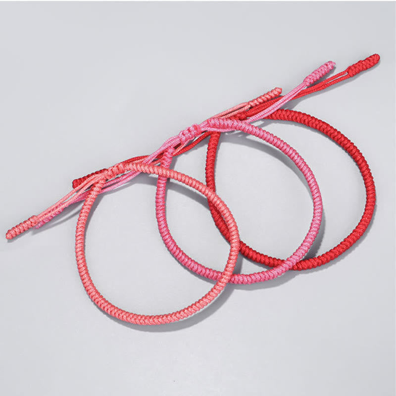 Tibetisches geflochtenes Armband Set in Rosa und Rot, drei Stück.