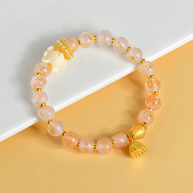 Armband Lotus – Glück mit Rosenquarz Perlen und goldenen Akzenten elegant.