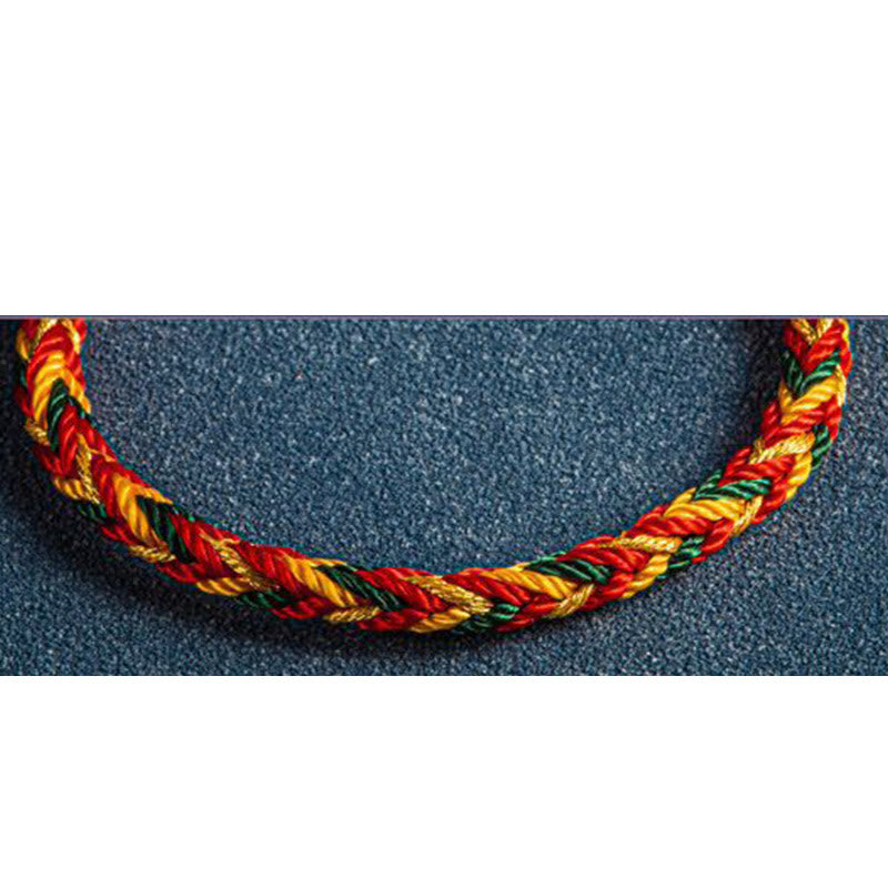 Mehrfarbiges Armband Flachlage rotes gelbes grünes Seil geflochten Textil