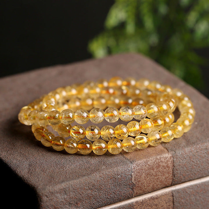 Armband Citrin – Schutz & Wohlstand goldene Perlen elastisches Armband getragen