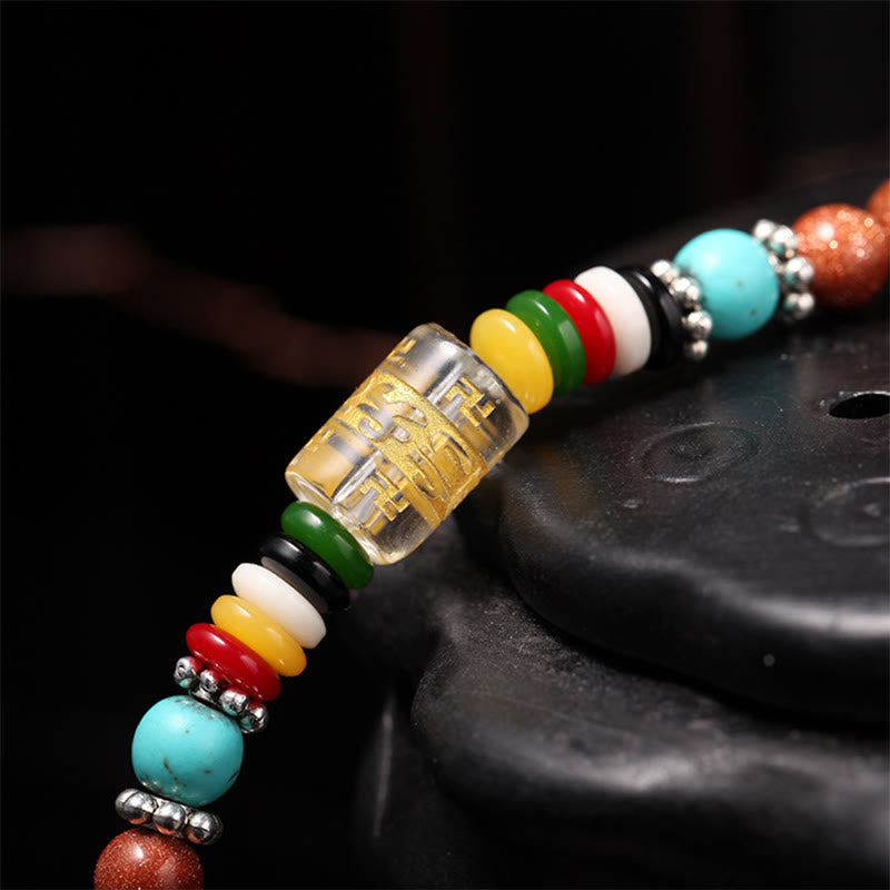Armband Om Mani Padme Hum Balance mit bunten Perlen auf schwarzem Stein.