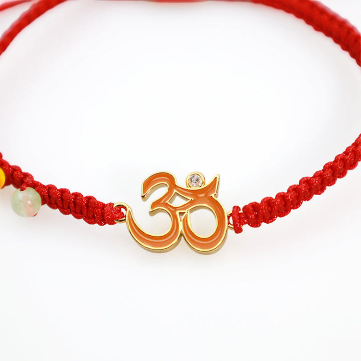 Armband Tibet OM Mindfulness Rotes Schnur Goldener Anhänger elastisch
