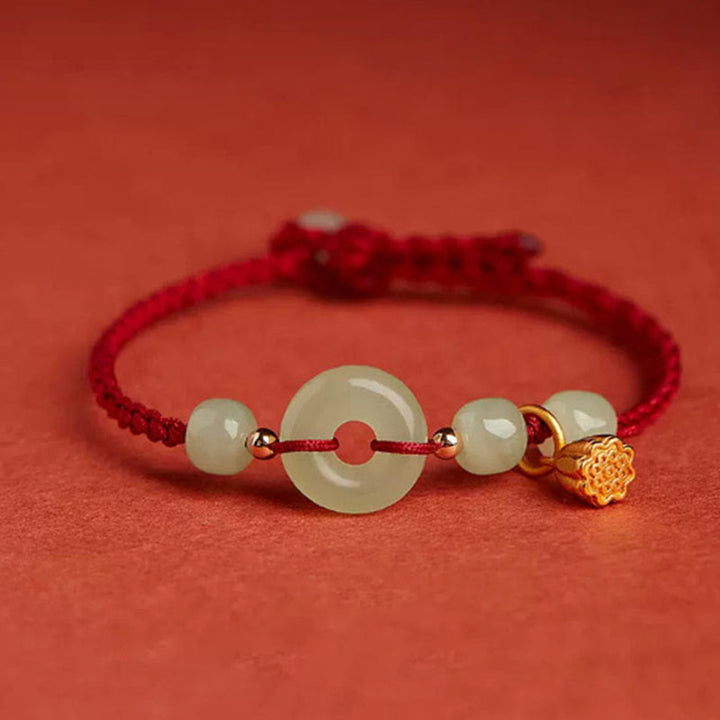 Armband Jade Lotus mit grünen Steinen rote Schnur goldene Verzierung Wohlstand Frieden