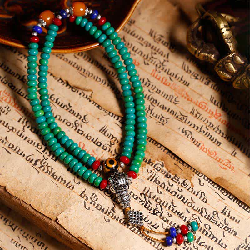 Mala 108 Perlen Türkis Armband mit bunten Perlen auf antikem Buch