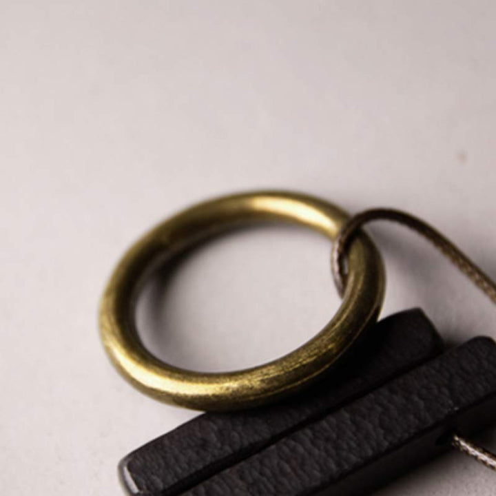 Anhänger Ebenholz Zen Kreis mit Messingring schwarzer Naturstein