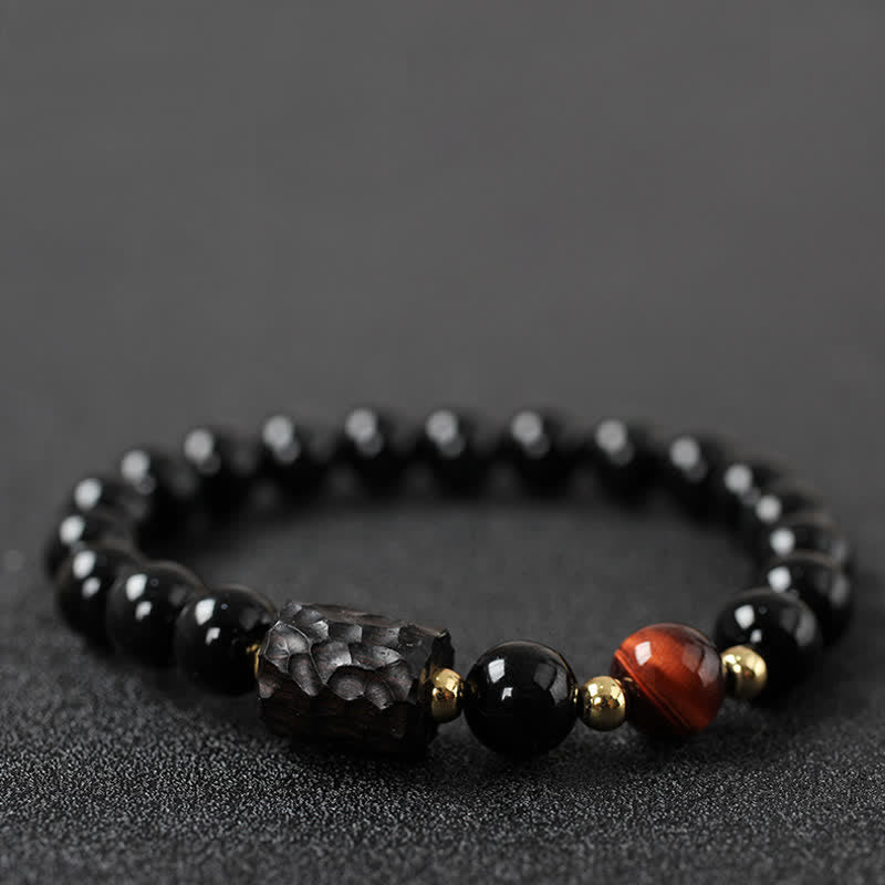 Schwarzer Obsidian Tigerauge Armband elastisch Naturstein Perlen golden glänzend.