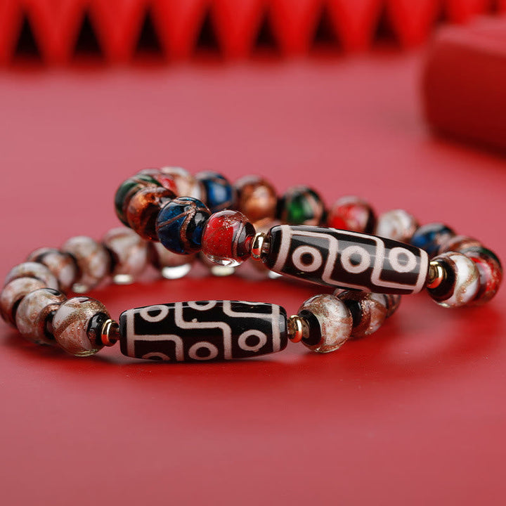 Armband – Wohlstand Balance mit roten Perlen und schwarzen Tibetan-Perlen elegant.