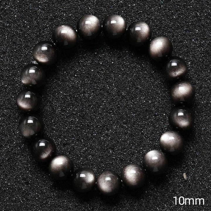 Silbernes Obsidian Armband Schutz schwarze glänzende Perlen Nahaufnahme Größenvergleich