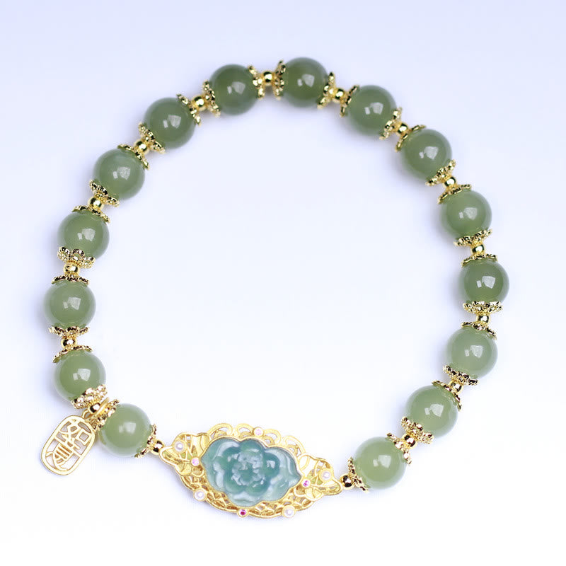 Grünes Jade Armband mit Lotus-Anhänger goldfarbig elegant gestylt.