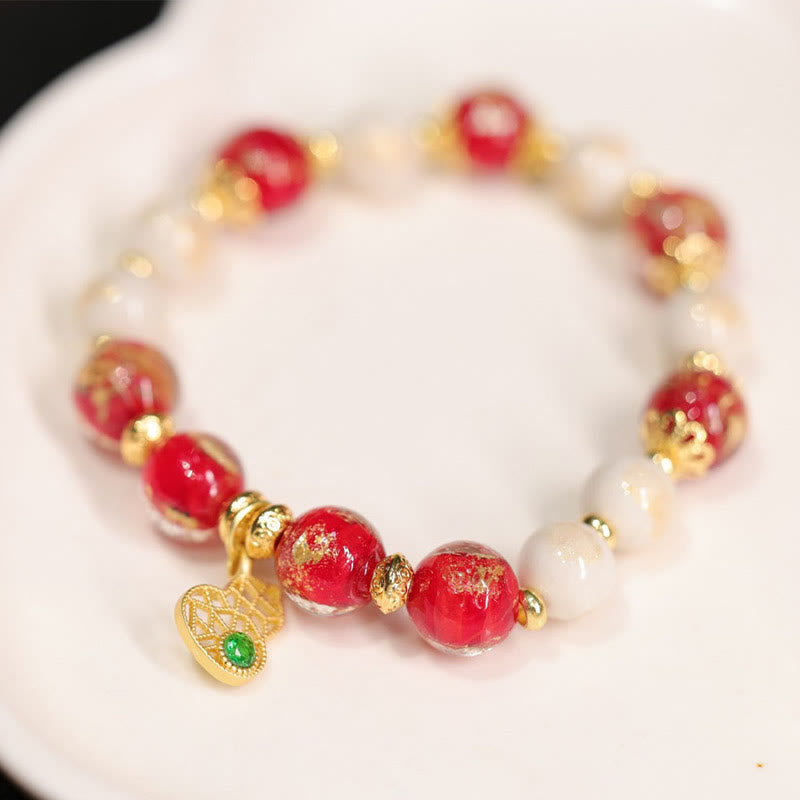 Armband Kürbis Wohlstand Glück Energie rote Perlen Goldakzente elegant