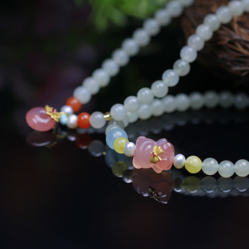 Armband Kristall Jade Frieden Glück weiße Perlen rosa Blüten Anhänger