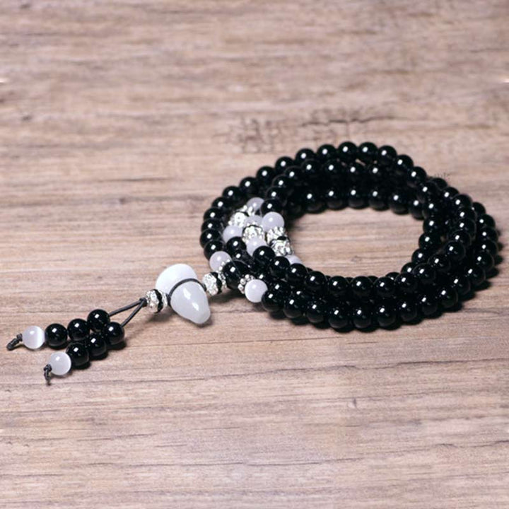 Armband Weißer Kristall Schwarzer Onyx elastisch handgefertigt Perlen