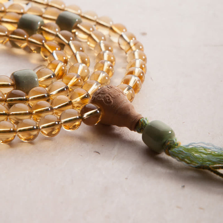 Mala Armband aus Sandelholz mit bernsteinfarbenen Perlen und Quaste.
