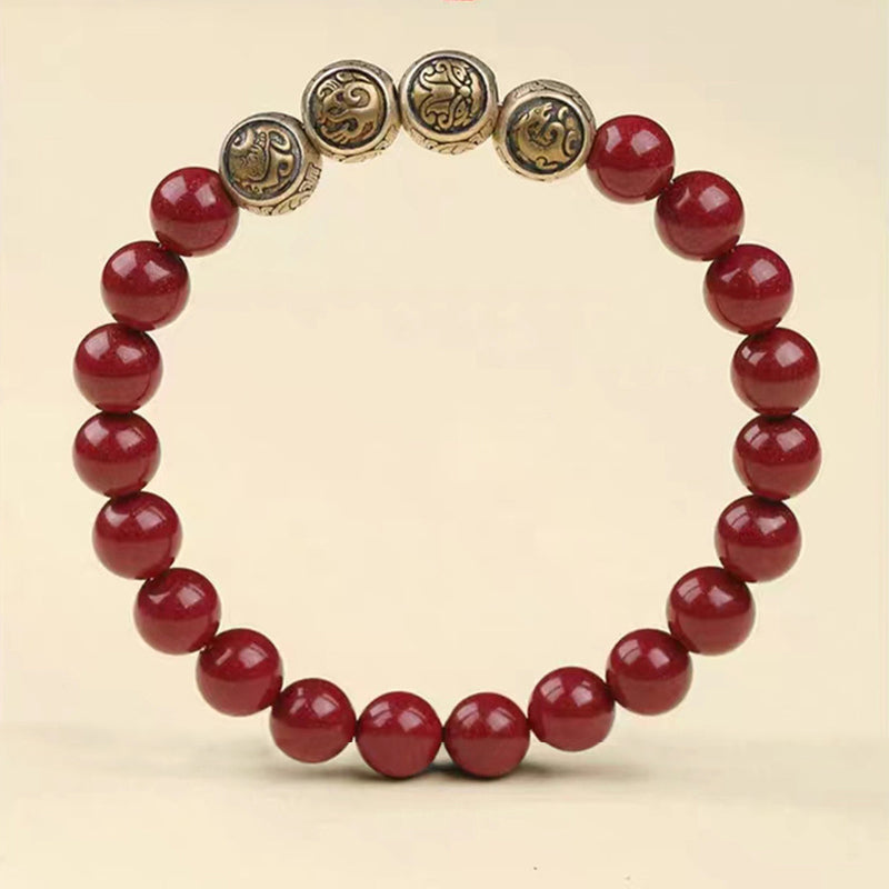 Rotes Zinnober Armband mit silbernen Glückszeichen Perlen elegant.