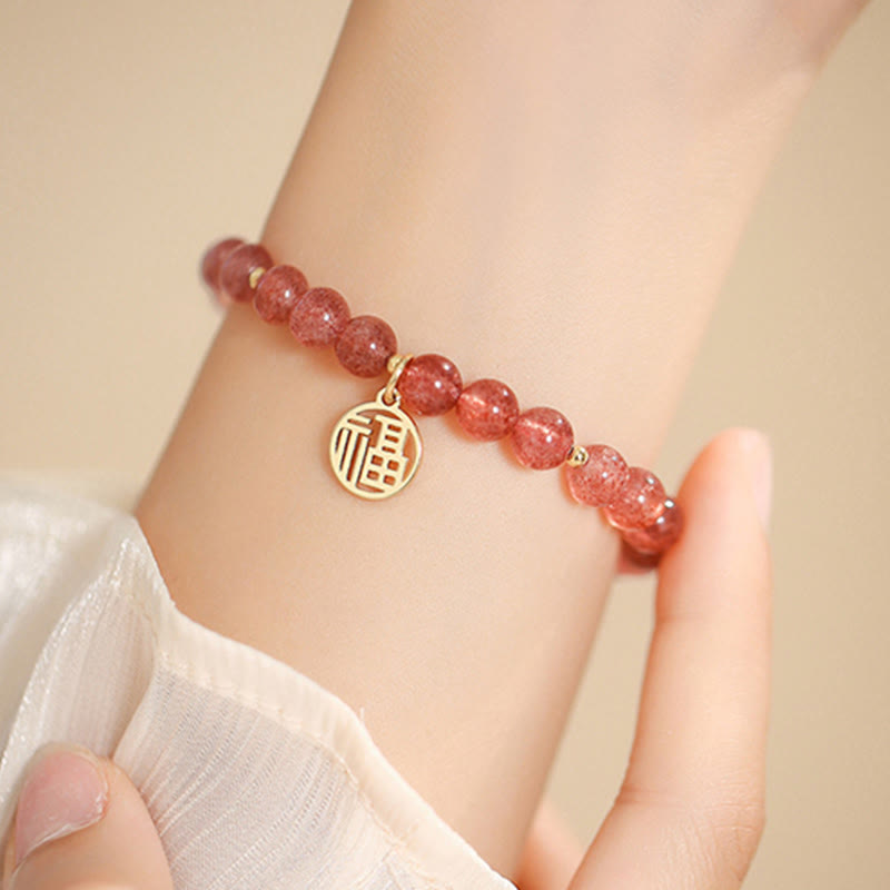 Armband Erdbeerquarz Fu-Zeichen Heilung Naturstein elastisch Handgelenk getragen