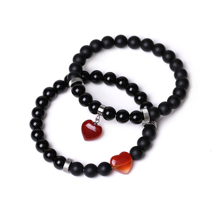 Armband Schwarzer Onyx Kristall Paar mit roten Herz-Anhängern elegant.