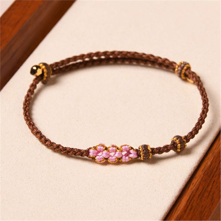 Armband Pfirsichblüte – Schutz braun rosa Perlen elastisch Handgelenk getragen