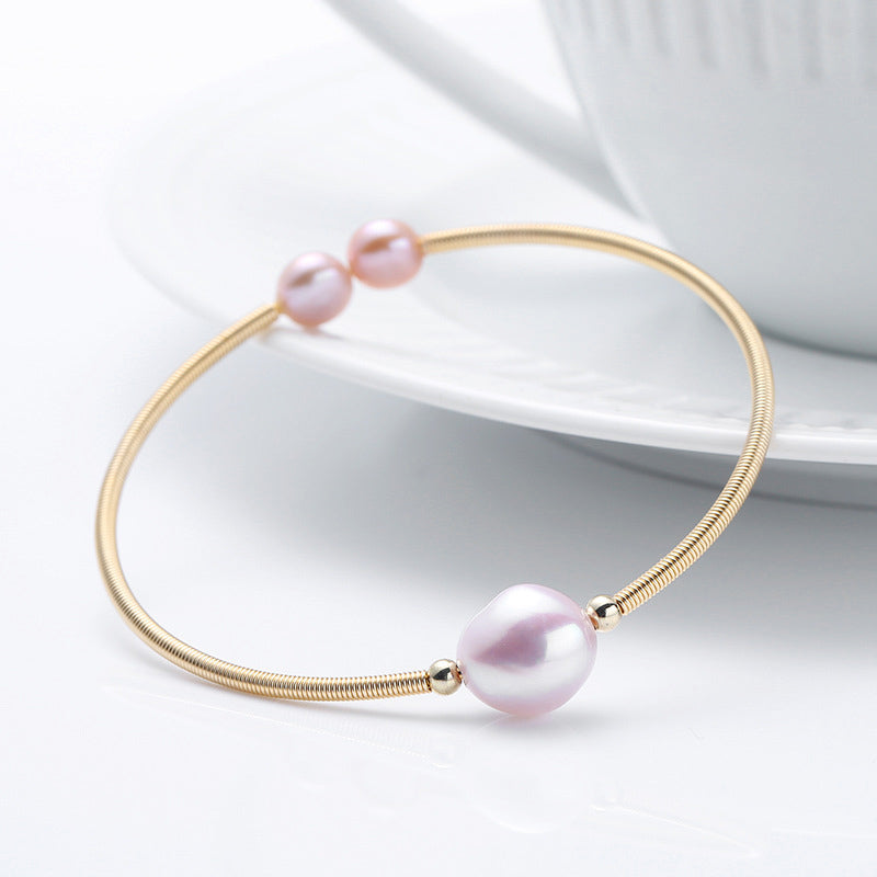 Armband Perle – Wohlstand rosafarbene Perle goldfarbenes Schmuckarmband elegant