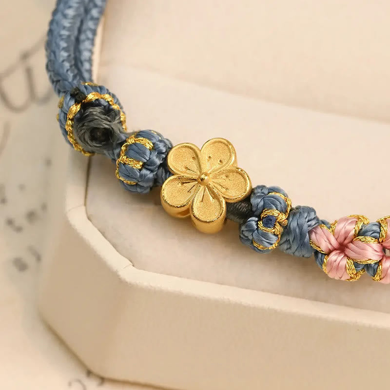 Armband Pfirsichblüte Wohlstand mit blauen Blüten Golddetails elegant