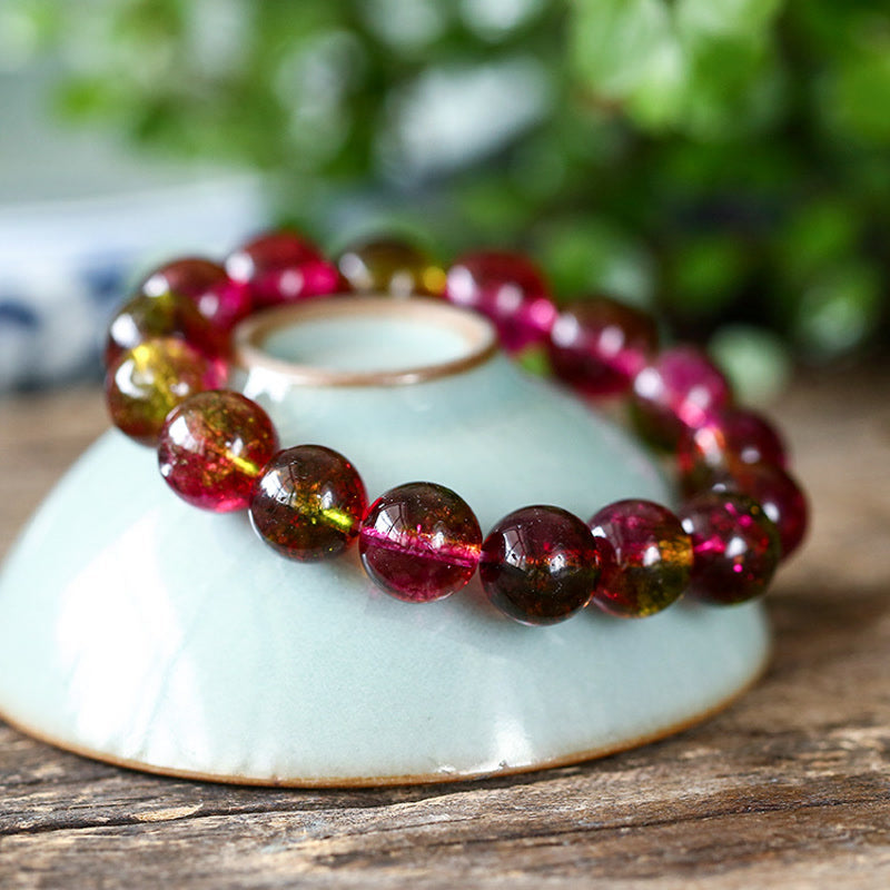 Tourmaline Armband Liebe Weisheit auf weißer Schale Naturstein rosa braun