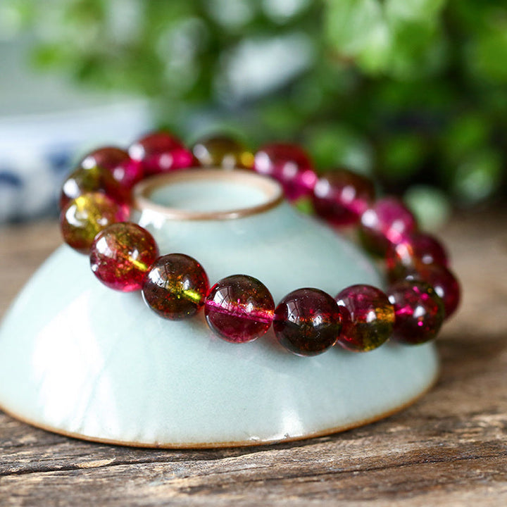 Tourmaline Armband Liebe Weisheit auf weißer Schale Naturstein rosa braun