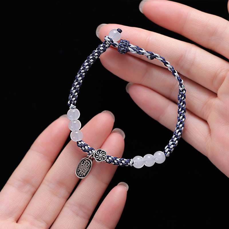 Armband Glücklich Glück mit weißen Perlen und Textilband getragen