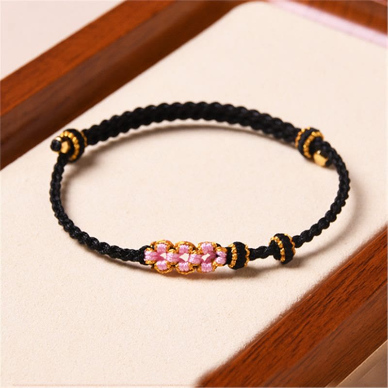 Armband Pfirsichblüte – Schutz schwarzes Seil rosa Perlen gold Details elastisch