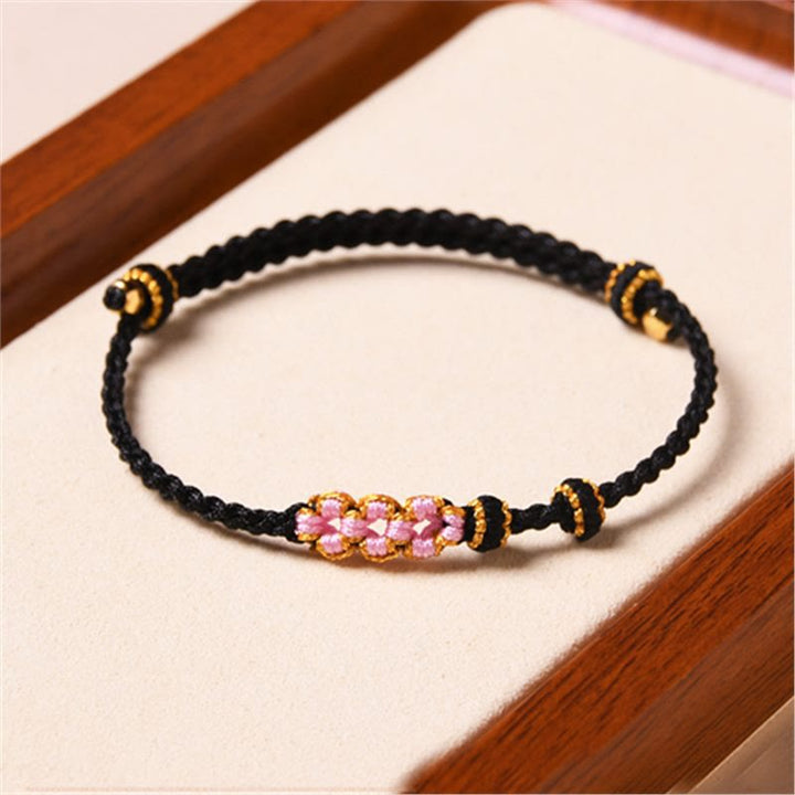 Armband Pfirsichblüte – Schutz schwarzes Seil rosa Perlen gold Details elastisch