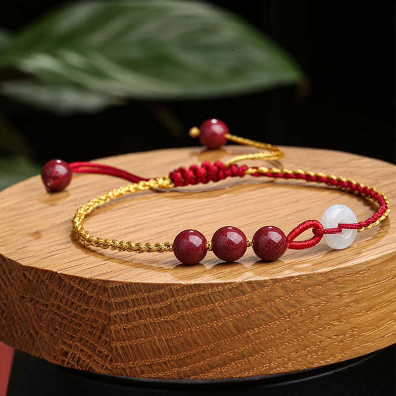 Armband Zinnober Jade – Frieden & Segen mit roten Perlen und goldener Schnur