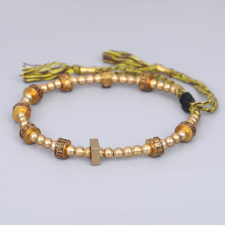 Tibetisches Armband mit goldenen Perlen und Quastenverschluss elegant.