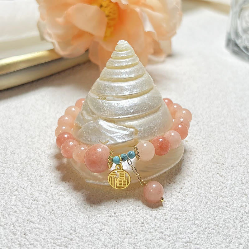 Roségoldenes Armband mit Perlen und Fu-Zeichen Glück Charm.
