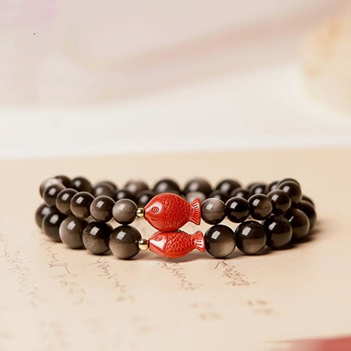 Obsidian Armband mit roten Koi Fischen Zinnober Perlen Schutz.