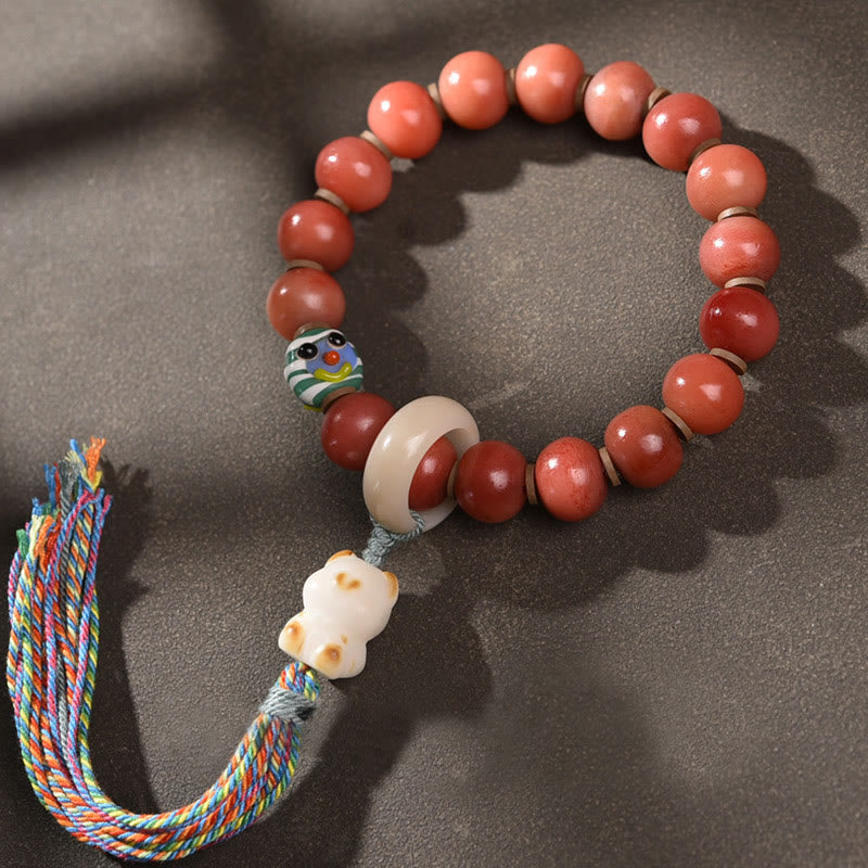 Armband Bodhi – Glück mit roten Perlen und Glücksbringer Anhänger.