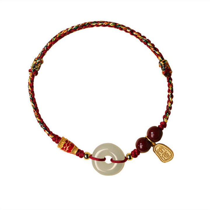 Jade-Donut Armband mit roten Perlen und goldenem Anhänger elegant.