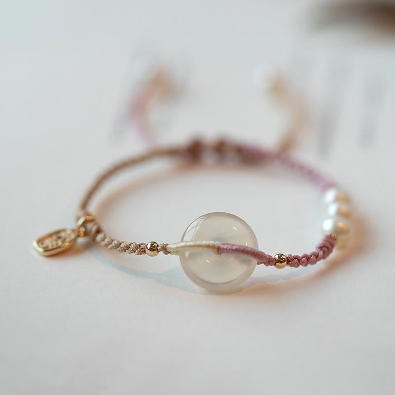 Armband – Frieden mit transparentem Mondstein und rosafarbenem Seidenfaden