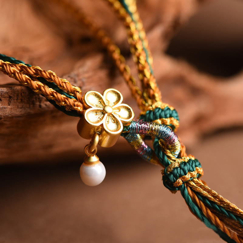 Armband – Heilung & Stärke goldene Blume Perle Seidenband elegant