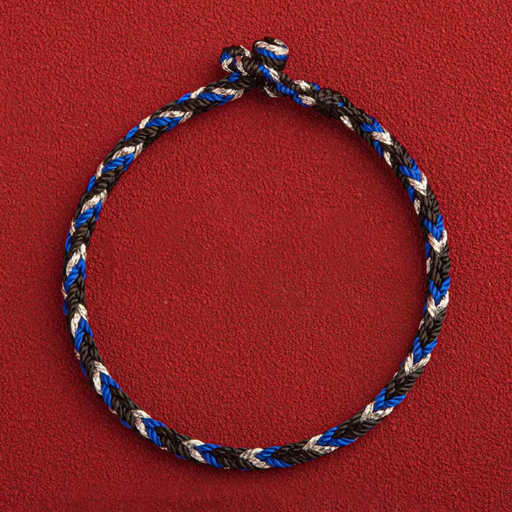 Glücksband Armband mehrfarbig blau schwarz weiß geflochten Flachansicht rot