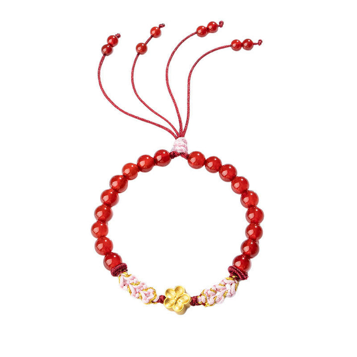 Rotes Achat Armband mit goldener Blume und rosa Kristallen elastisch.