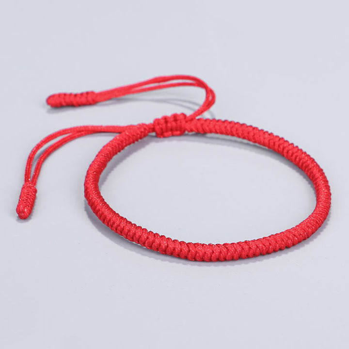 Rotes geflochtenes Armband Tibet Knoten Schutz elastisch verstellbar.