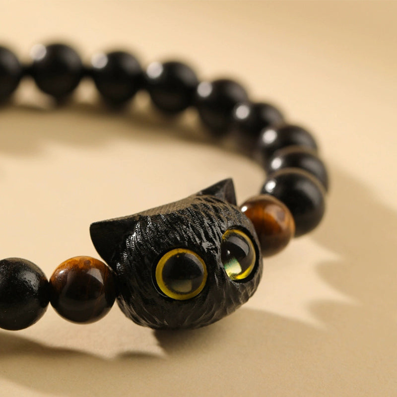 Armband Ebenholz Katze schwarze Perlen gelbe Augen Energie Schutz
