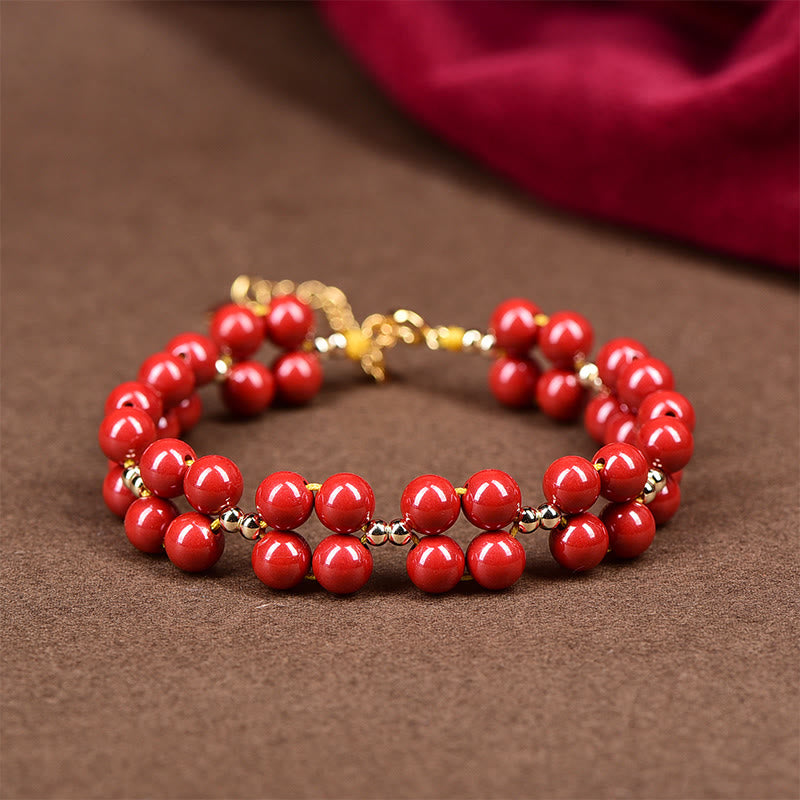 Armband Zinnober – Segen Harmonie rote Perlen Goldakzente elegant glänzend