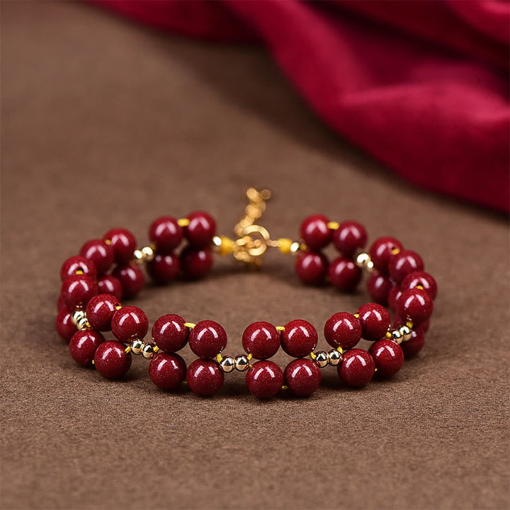 Armband Zinnober – Segen Harmonie rote Perlen Goldakzente elegant