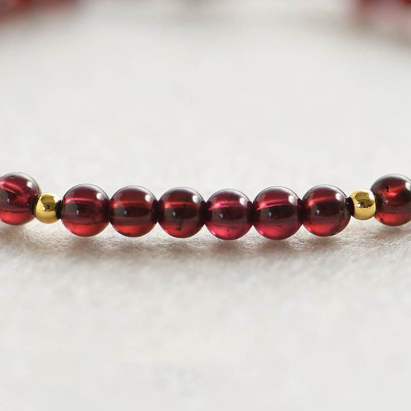 Armband mit roten Granaten und goldenen Perlen Stabilität