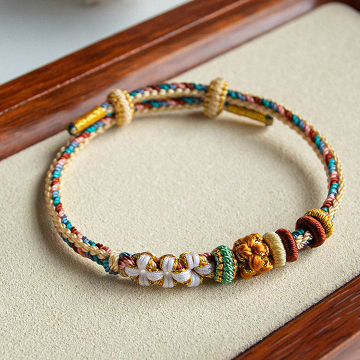 Buntes Armband Pfirsichblüte mit goldenen Perlen Stoffband elastisch.